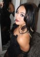 Roxanne Perez poses glamorously in a black dress with elegant makeup, showcasing her signature style.