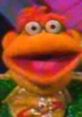 Scooter from The Muppets, known for his vibrant personality and humor in "You're The Director." Fun puppet character!