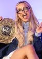LIV MORGAN celebrates with a WWE championship belt, showcasing her playful personality and iconic style.