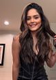 Tay Melo shows off her gorgeous long hair and radiant smile in a stylish black outfit, exuding confidence and charm.