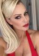 Maryse Ouellet wearing a striking red outfit, showcasing her signature glamorous style and captivating expression.