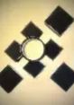 Black squares arranged around a circular object, representing Anomidae's unique morphology and structure.