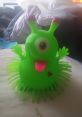 Colorful green Mack The Monster toy with round body, playful eyes, and spiky limbs, perfect for fun and imaginative playtime.