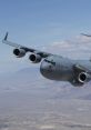 Boeing C-17A Globemaster III in flight, showcasing its impressive design and capabilities in a clear blue sky.