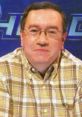 Kevin Ashman smiling in a plaid shirt, known for his expertise in quiz and trivia competitions.
