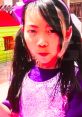 Young girl in sparkly purple top, playfully engaging with colorful toys in a vibrant outdoor setting. Excitement and creativity shine.