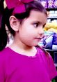 Young girl with pigtails and a bright pink bow, showcasing vibrant colors, ideal for Ellie Toys And Colors (2021) themes.