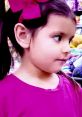 Young girl with a pink bow and shirt, showcasing vibrant engagement with Ellie Toys & Colors products in a playful setting.