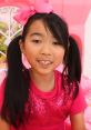 Cheerful girl in a sparkly pink outfit, showcasing the fun and creativity of Lucy Toys And Colors (2002-2003) Season 1-2.