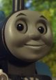 Cheerful Thomas the Tank Engine character with bright eyes, showcasing his iconic smile against a lush background.