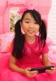 Cheerful girl in pink dress and bow, enjoying playtime with Lucy Toys and Colors, bright and playful setting.