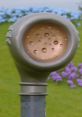 Voice Trumpet from Teletubbies 1997, featuring a green landscape with colorful flowers in the background.
