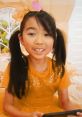 Young girl in orange and golden outfit with pigtails, showcasing vibrant colors for Lucy Toys and Colors Season 3.