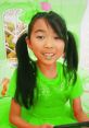 Lucy in vibrant green clothes, playing with colors, showcasing her fun style for Season 4 of Lucy Toys and Colors.