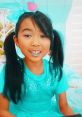 Lucy in vibrant blue clothes, showcasing her playful style from Season 6-7, with a joyful smile and colorful accessories.
