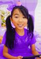 Cheerful child in stylish indigo outfit playing, showcasing Lucy Toys and Colors fashion for kids, season 8-11.