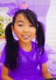 Girl with pigtails in a sparkly purple outfit, enjoying playtime in a vibrant pink room, inspired by Lucy Toys and Colors.