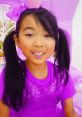 Lucy character playfully dressed in purple, embracing creativity in "Toys and Colors" themed adventures. Fun playdate vibes!