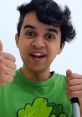 Young boy in a green shirt giving a thumbs up, celebrating creativity and fun with Uncle Jim Toys And Colors.