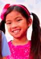 Cheerful girl in a pink sparkly shirt with pigtails, perfect for "Toys And Colors Emma Season 1 Play Date Adventures.