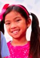 Smiling girl in a pink sparkly shirt, promoting creativity with Emma Toys and Colors from Nicktoons. Perfect for playtime fun!