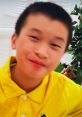 Boy in a bright yellow shirt smiling, showcasing joy and creativity, perfect for "Andrew Toy and Colors" theme.
