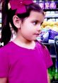 Young girl in a pink shirt and bow, showcasing vibrant colors amidst grocery items, perfect for Ellie Toys and Colors 2022.