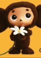 Cheburashka holding a flower against an orange background, showcasing its adorable and playful character.
