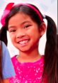 Smiling girl with pigtails in a sparkly pink top, representing fun and creativity from Emma Toys And Colors.