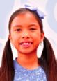 Cheerful girl with long hair and a blue bow, smiling brightly, perfect for children's content and branding related to Wendy (4).