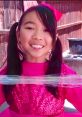 Cheerful child in a pink sparkly outfit, showcasing fun and creativity with Lucy Toys And Colors 2020. Joyful playtime vibes!
