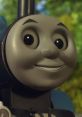 Close-up of Thomas the Tank Engine, featuring the Pierce Brosnan version, showcasing his friendly expression and bright eyes.