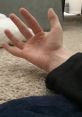Open hand resting on a soft surface, showcasing fine details of fingers and palm in a cozy setting.