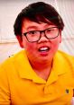 Young boy in a bright yellow shirt, engaging with Vinnie Toys & Colors, displaying excitement and curiosity.