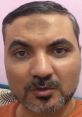 Man with a beard speaking directly, showcasing tactics used by scammers in India to gain trust and manipulate victims.