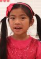 Cheerful girl with pigtails and a pink bow, showcasing bright colors and sparkle in a fun, vibrant setting.