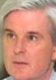 Close-up of a serious man with light gray hair, focusing on a conversation or interview setting reminiscent of Conradtcp themes.