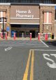 Entrance view of a Home & Pharmacy store showcasing safety barriers and pedestrian pathways in a sunny outdoor setting.