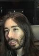Penguin Z discussing recent video content, showcasing his signature long hair and engaging expression.
