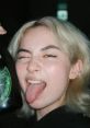 Kyedae making a playful face while holding a drink, showcasing her fun personality and vibrant style.