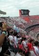 Energetic crowd at a football match, showcasing team spirit, celebrating with Legia Warszawa Football Club songs and colors.