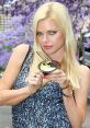londe woman holding a dessert, promoting Sara Lee products, with purple flowers in the background.