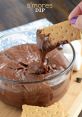 Delicious s'mores dip with graham cracker for dipping, featuring rich chocolate and gooey marshmallow flavors.