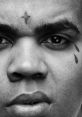 Close-up of a man with distinctive tattoos, capturing a serious expression, highlighting urban style and emotion.