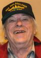 Smiling man wearing a USS Philadelphia cap, representing military pride and the legacy of veterans.