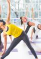 Group yoga session indoors, featuring women performing various poses to enhance flexibility and promote wellness.