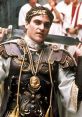 Commodus in Gladiator, adorned in luxurious armor, brandishes a sword, exuding power and ambition in ancient Rome.