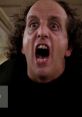 Intense close-up of a man screaming, embodying the spooky energy of "The Ghost Guy" in a classic horror scene.