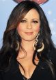 Sara Evans at a red carpet event, showcasing her signature style with glamorous makeup and elegant accessories.