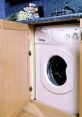Compact kitchen appliance doors concealing a washing machine in a stylish cabinetry setup for space-saving design.